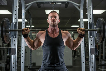 Man lifting barbell on a Smith machine in a gym