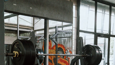 squat rack and weights in a bright gym